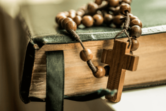 rosary on the bible