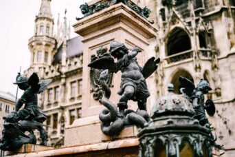 Angel defeating a dragon at a column. Statue at Marienplatz in Munich
