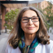 older woman with glasses smiling